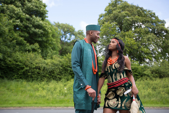 Bride and groom in traditional Nigerian clothing looking at each other